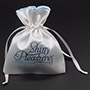 White satin bag with blue satin lining, with satin rattail drawstring.
