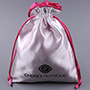 White satin bag with fuchsia satin lining, with satin rattail drawstring.